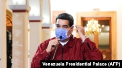 VENEZUELA -- Venezuelan President Nicolas Maduro wearing a face mask while speaking during a televised announcement over the global COVID-19 coronavirus pandemic, in Caracas, March 13, 2020.