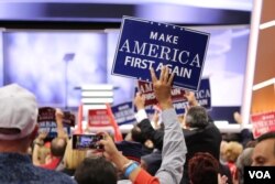 FILE - A delegate holds a "Make America First Again" sign at the Republican National Convention, July 20, 2016 (A. Shaker/VOA). So far, there's been no major revolt from supporters of President Donald Trump, despite their expectation he would be an agent of disruption.