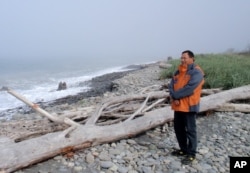 Robert Elofson stands on an eroded Lower Elwha Klallam reservation beach that he hopes will be repopulated with clams after it is nourished with river sediments now trapped behind two Elwha River dams.