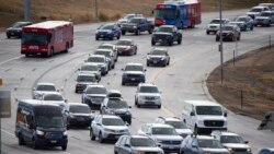 Motorists move slowly on Pena Boulevard as traffic increases with the approach of the Thanksgiving Day holiday Nov. 23, 2021, at Denver International Airport in Denver.