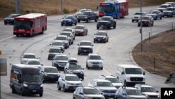 Motorists move slowly on Pena Boulevard as traffic increases with the approach of the Thanksgiving Day holiday Nov. 23, 2021, at Denver International Airport in Denver.