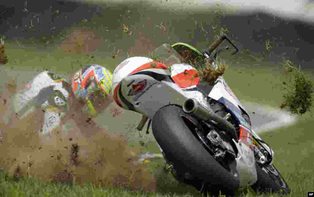 Xavier Simeon, of Belgium, crashes during Indianapolis Moto 2 motorcycle race at the Indianapolis Motor Speedway in Indianapolis, Indiana, USA.