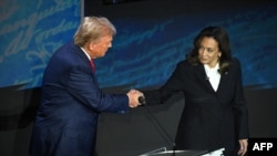 FILE - U.S. Vice President Kamala Harris shakes hands with former U.S. President Donald Trump during a presidential campaign debate in Philadelphia, Pennsylvania, on Sept. 10, 2024. After the debate, Cuban state-run newspaper Granma reported that the two traded "low blows."