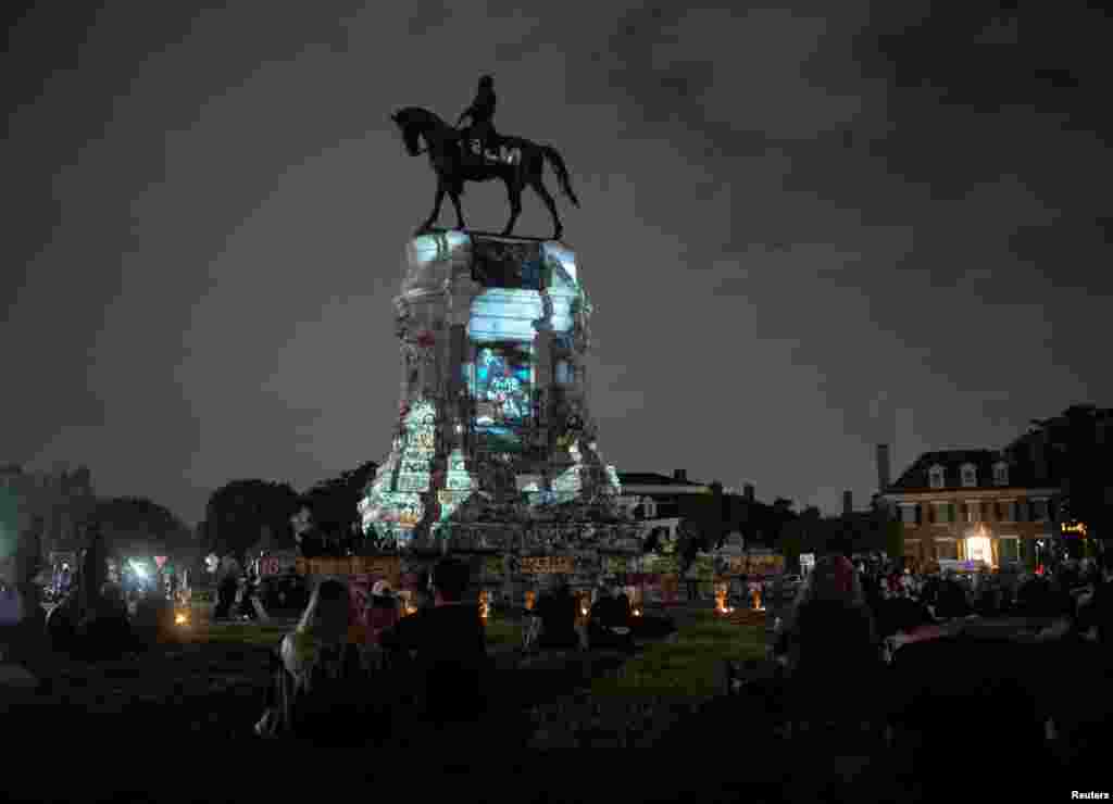 An image of Frederick Douglass is projected onto the statue of Confederate general Robert E. Lee in Richmond, Virginia, July 1, 2020.