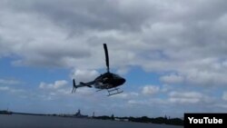 A screengrab from YouTube video showns a Bell 206 helicopter as it goes down in Pearl Harbor, Hawaii, Feb. 18, 2016. (Video courtesy - Shawn Winrich)