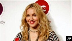 Madonna smiles as she poses for pictures during the opening of Hard Candy Fitness, her new gym in Mexico City, 29 Nov. 2010