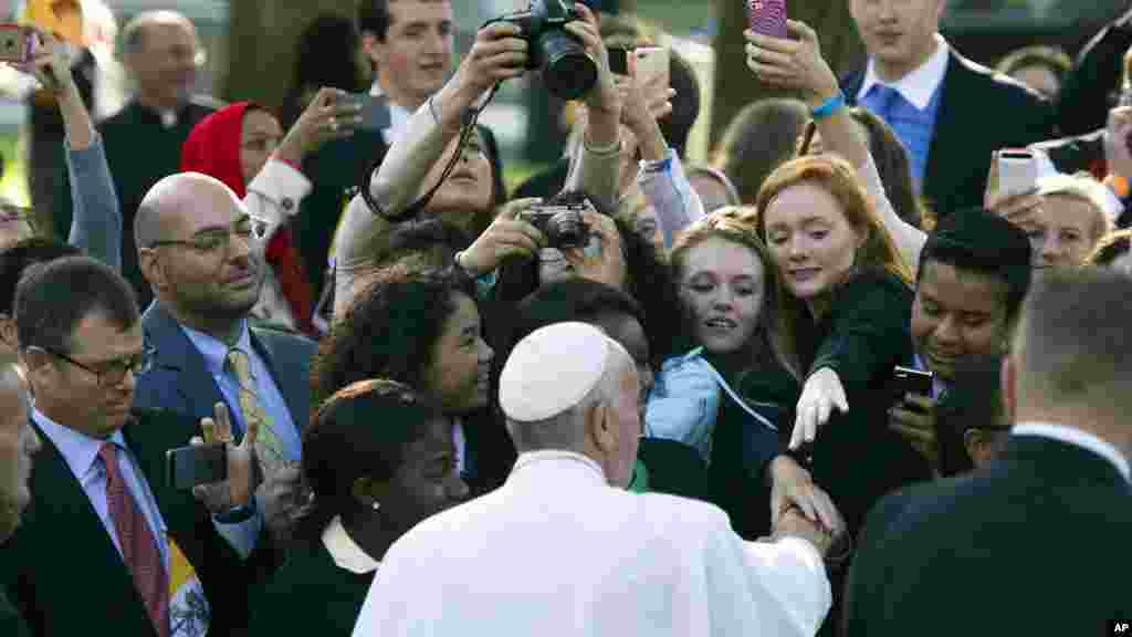Pope Francis greets well-wishers while departing for the White House from the Apostolic Nunciature, the Vatican&#39;s diplomatic mission in Washington, Sept. 23, 2015.