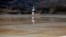 FILE - The old church of Geamana village is partially submerged by polluted water tainted with cyanide and other chemicals near Rosia Montana, central Romania, March 24, 2014. 