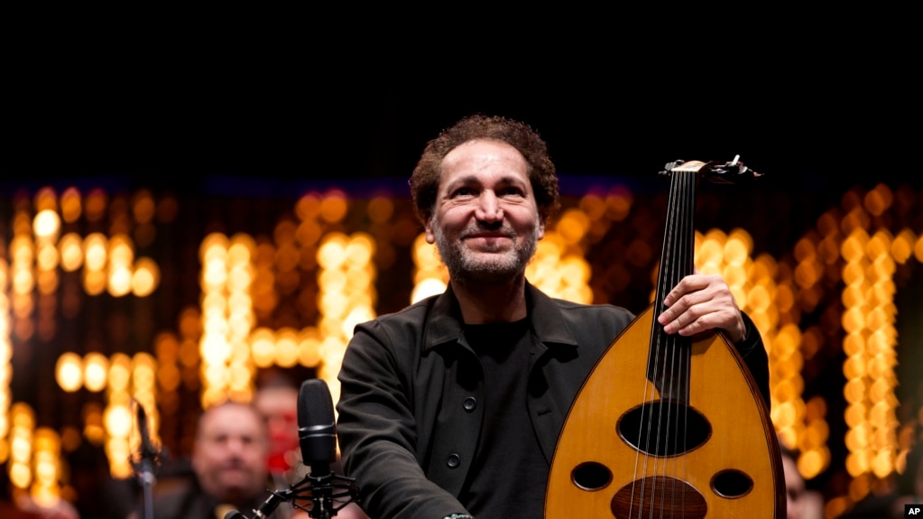 Iraqi virtuoso oud player Naseer Shamma prepares to perform with an orchestra, at the Iraqi National Theater in Baghdad, Iraq, Friday, Jan. 21, 2022. (AP Photo/Hadi Mizban)