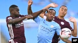 Leicester's Nampalys Mendy, left vies for the ball with Manchester City's Raheem Sterling, center and Leicester's Youri Tielemans during the English Premier League soccer match between Manchester City and Leicester City at the Etihad stadium in Manchester