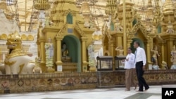FILE - President Barack Obama, right, tours the Shwedagon Pagoda in Yangon, Myanmar, November 19, 2012. 