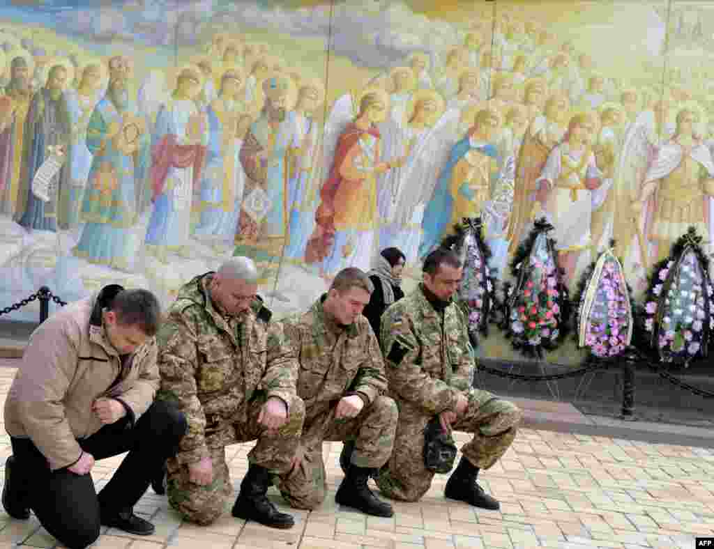 Bạn bè tiễn biệt binh sĩ nhảy dù người Ukraine Igor Branovitsky, 38 tuổi, thiệt mạng trong chiến sự ở miền đông Ukraine, tại đám tang ở phía trước của nhà thờ Mikhaylovsky, trung tâm Kiev.