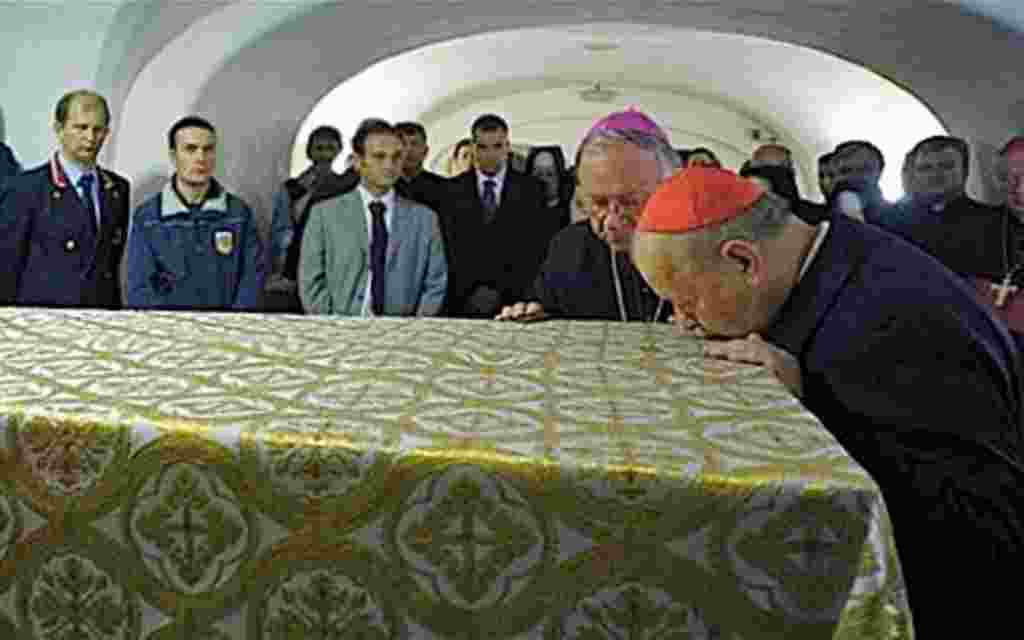 Archbishop of Kraków, and former John Paul II's secretary Stanislaw Dziwisz (r) kisses the coffin of late Pope John Paul II ahead of the beatification ceremony, April 29, 2011