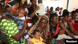 Women and their children visit a clinic at Sinza Health Centre in Tanzania's capital Dar es Salaam May 2, 2011. 