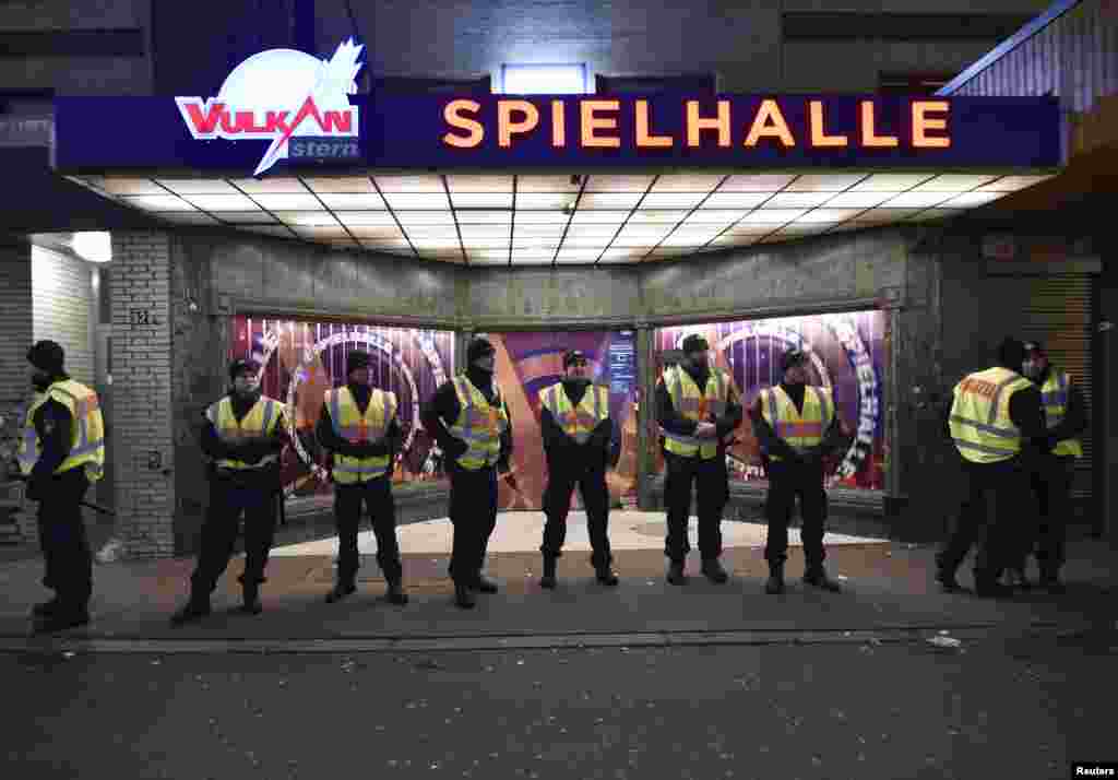 German police guard the venue at the Reeperbahn street in St.Pauli red-light district before the New Year celebrations for 2017 in Hamburg, Dec. 31, 2016.