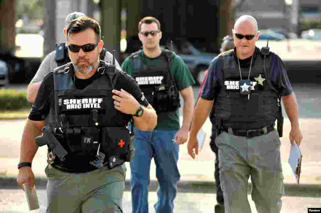 Officers arrive at Orlando Police Headquarters during the investigation of a shooting at the Pulse nightclub, Orlando, Florida, June 12, 2016.