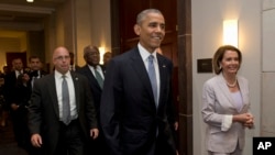 President Barack Obama walks with House Minority Leader Nancy Pelosi of Calif., right and House Minority Assistant Leader James Clyburn of S.C., as he visits Capitol Hill in Washington, June 12, 2015.