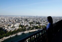 A visitor looks at the view from the Eiffel Tower, in Paris, June 25, 2020.
