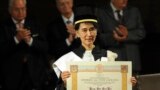 Aung San Suu Kyi, Burma's Nobel Peace Prize laureate and former long-time political prisoner, poses with her honorary degree in Philosophy from the University of Bologna, central Italy.
