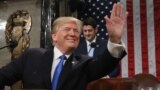 U.S. President Donald Trump waves as he arrives to deliver his first State of the Union address to a joint session of Congress inside the House Chamber on Capitol Hill in Washington, U.S.