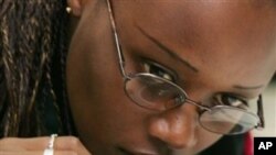 Angelique Karekeki, general manager of KOAKAKA cooperative in Rwanda, judges the odor of a coffee while taste testing. Coffee is one export from Rwanda. (file)