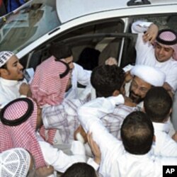 Saudi Shi'ite cleric Tawfiq al-Amir (R) greets supporters in Al-Ahsa, Mar 6 2011, after his release from prison. He was arrested for calling for a constitutional monarchy and a fight against corruption, witnesses and human rights activists said