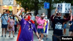 Protesters march against Spain's monarchy for the first time since former Spanish King Juan Carlos left the country amid an investigation into his involvement in a high-speed rail contract in Saudi Arabia, in Madrid, Spain Aug. 9, 2020.