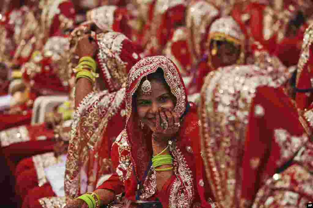 An Indian Muslim bride smiles as she sits with other brides during a mass wedding organized by a social organization in Ahmadabad.