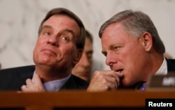Committee Vice Chairman and ranking member Senator Mark Warner, left, and Chairman Richard Burr listen as U.S. Attorney General Jeff Sessions testifies before a Senate Intelligence Committee hearing on Capitol Hill in Washington, June 13, 2017.