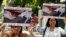 FILE - Members of the movement Laity of Osorno hold up images showing the Rev. Fernando Karadima, left, and his protege Juan Barros, bishop of Osorno, with a message that reads in Spanish: "A bishop who covers up cannot be a priest," during a protest in front of the Apostolic Nunciature in Santiago, Chile, Jan. 12, 2018.