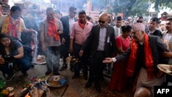 Nepali Prime Minister K.P. Sharma Oli (R) takes part in a ritual as he visits the reconstruction site of Kathmandu's Durbar Square, which was damaged by the 2015 earthquake, on the fourth anniversary of the disaster in Kathmadu, April 25, 2019.