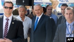 Israeli Prime Minister and Likud party's candidate running for general elections, Benjamin Netanyahu is surrounded by bodyguards during his visit in Har Homa, an Israeli settlement neighborhood of annexed east Jerusalem, March 16, 2015.