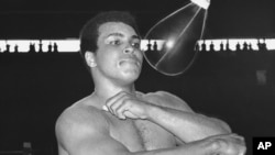 FILE - Muhammad Ali, world heavyweight champion, punches speed bag at the Folk Art Center in Manila, Philippines, Sept. 29, 1975, as he prepares his title fight on October 1 with Joe Frazier. 