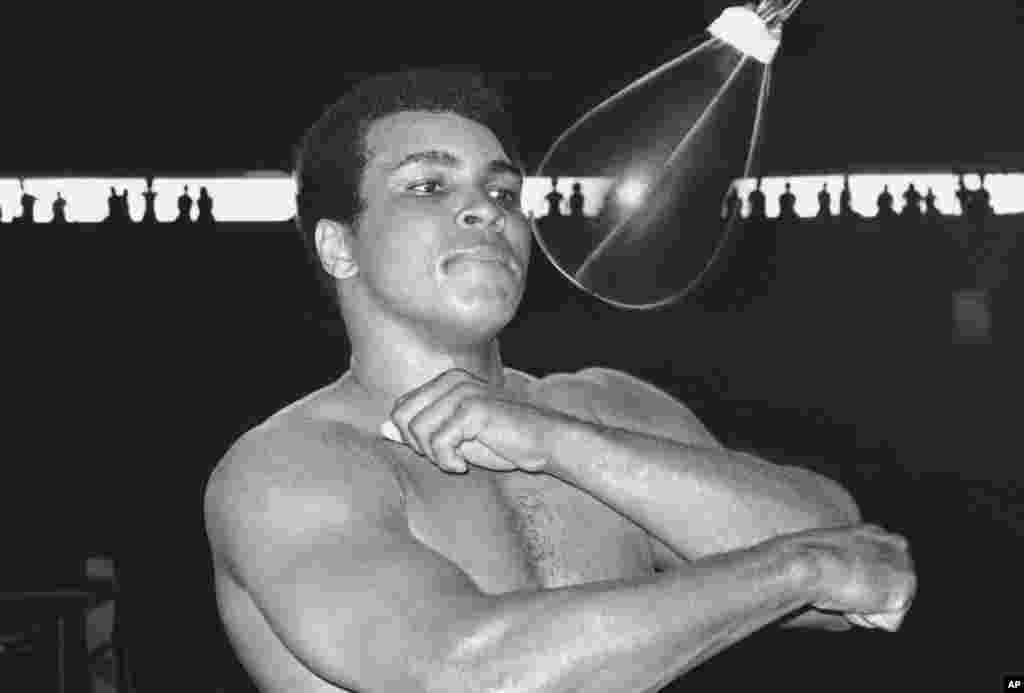 FILE - Muhammad Ali, world heavyweight champion, punches speed bag at the Folk Art Center in Manila, Philippines, Sept. 29, 1975, as he prepares his title fight on October 1 with Joe Frazier. 