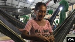 Maria Centeno weaves a hammock at the Pintolandia refugee camp in Boa Vista, Brazil. 