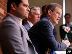 Boston Red Sox president Sam Kennedy, right, addresses the media during a news conference updating the status of former Red Sox designated hitter David Ortiz at Fenway Park, June 10, 2019.