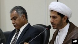 File - Opposition leaders Radhi Mohsen al-Mosawi (L) and Sheikh Ali Salman speak at a joint press conference in Umm Al Hassam, Bahrain.