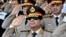 FILE - In this July 22, 2013, file photo released by the Egyptian Presidency, Defense Minister Gen. Abdel-Fattah el-Sissi, listens to the national anthem during a medal ceremony at a military base east of Cairo