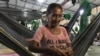 Maria Centeno weaves a hammock at the Pintolandia refugee camp in Boa Vista, Brazil. 