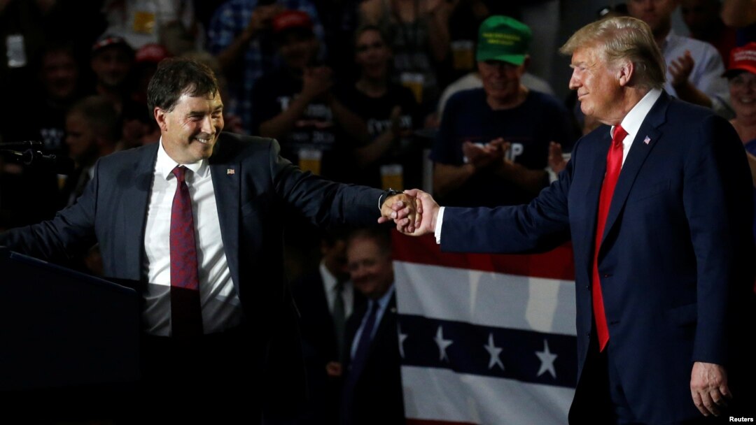Ohio Senator Troy Balderson shakes hands with U.S. President Donald Trump during a Make America Great Again rally in Olentangy Orange High School in Lewis Center, OH, Aug. 4, 2018.