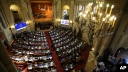 FILE - Lawmakers debate in Congress in Bogota, Colombia, Nov. 30, 2016. They have approved the creation of special courts for the prosecution of war crimes, a key component of the historic peace agreement reached with the country's largest rebel group.