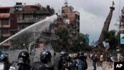 Nepalese protesters defying a government coronavirus lockdown to take part in a religious festival clash with riot police, in Lalitpur, Nepal, Thursday, Sept. 3, 2020.