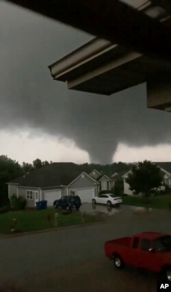 This still image taken from video provided by Chris Higgins shows a tornado, May 22, 2019, in Carl Junction, Mo. The tornado caused some damage in the town of Carl Junction, about 4 miles (6.44 kilometers) north of the Joplin airport.