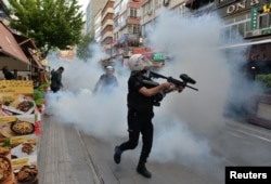 Riot police use tear gas to disperse demonstrators during a protest against the detention of two hunger-striking teachers in Ankara, Turkey, May 22, 2017.
