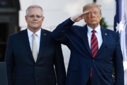 FILE - President Donald Trump and Australian Prime Minister Scott Morrison listen to the National Anthem during an State Arrival Ceremony on the South Lawn of the White House in Washington, Sept. 20, 2019.