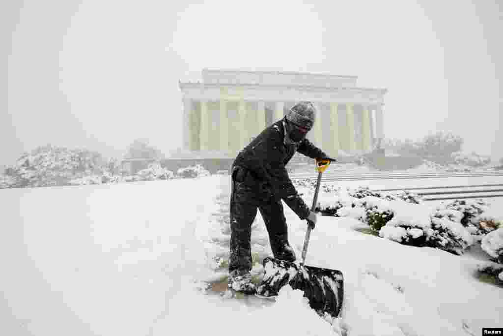 Un trabajador del Parque Nacional limpia la nieve frente al Lincoln Memorial durante la tormenta de nieve.