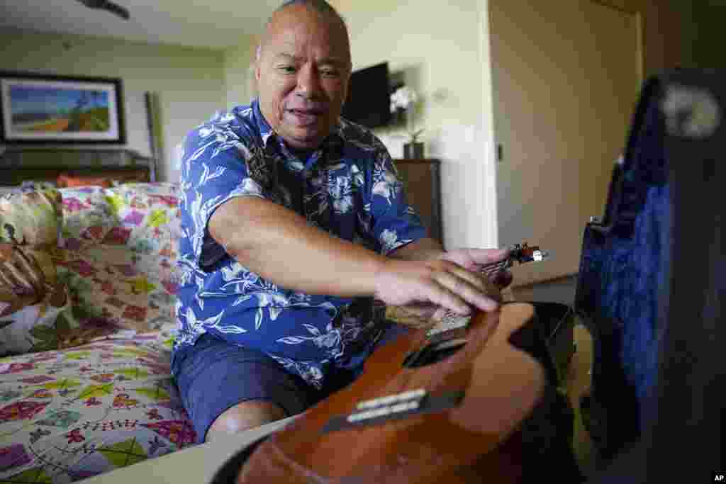 Charles Nahaale holds a ukulele gifted by his friend after Nahale lost most of his instruments from August&#39;s wildfire on Oct. 10, 2023, in Lahaina, Hawaii.&nbsp;