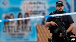 Armed police officers patrol a police cordon near the Manchester Arena in Manchester, May 24, 2017. 