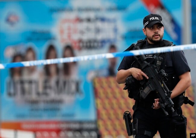 Armed police officers patrol a police cordon near the Manchester Arena in Manchester, May 24, 2017.