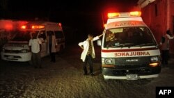 Two ambulances stand on the scene of a bomb attack at Lido Beach, in Mogadishu, Somalia, Jan. 21, 2016. 